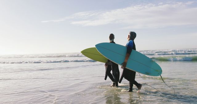 Senior african american couple walking with surfboards at the beach - Download Free Stock Photos Pikwizard.com