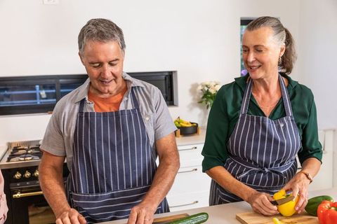 Senior Couple Preparing Fresh Ingredients in Modern Kitchen
