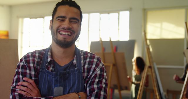 Smiling Artist in Studio with Crossed Arms - Download Free Stock Images Pikwizard.com