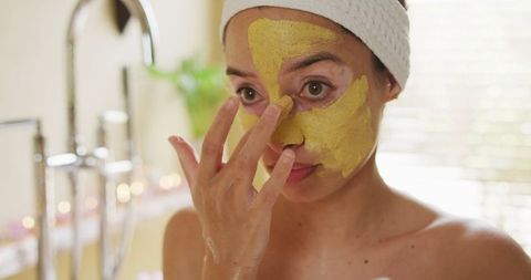 Woman Applying Face Mask in Bathroom for Skin Care Routine