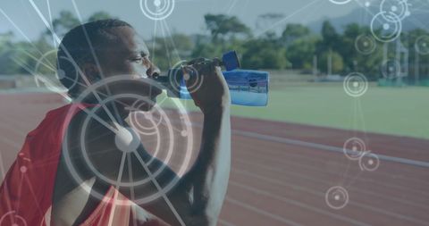 Athlete Hydrating on Track with Digital Network Overlay