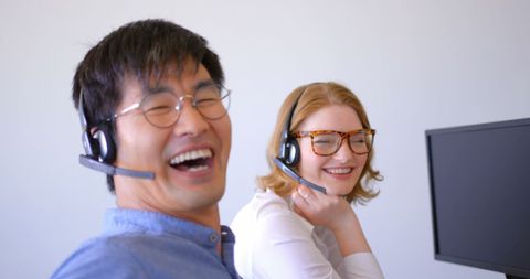 Joyful Customer Support Representatives Working in Modern Office