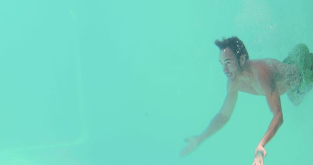 Man Swimming Underwater in Clear Pool - Download Free Stock Images Pikwizard.com