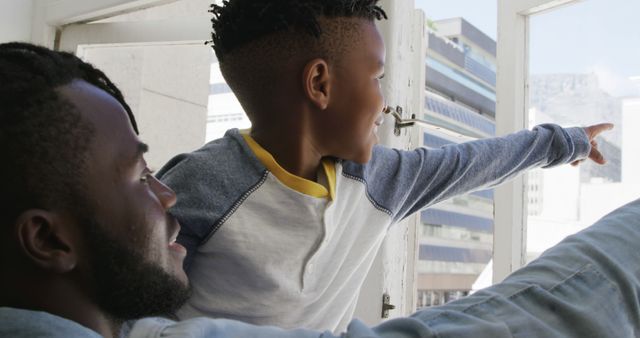 Father and Son Enjoying Urban View Through Window - Download Free Stock Images Pikwizard.com