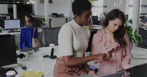 Colleagues Collaborating on Laptop in Modern Office Environment