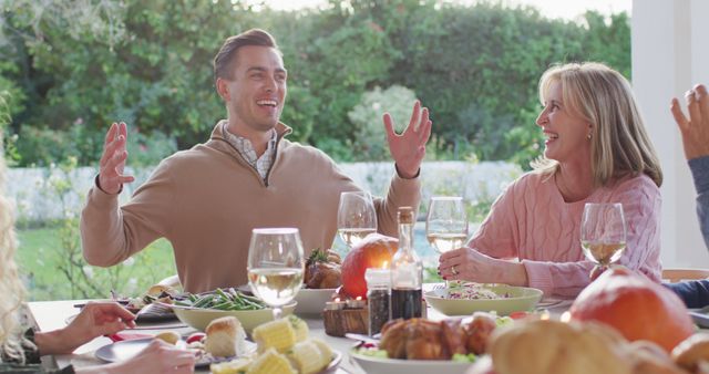 Image of happy caucasian father telling story at outdoor family dinner table - Download Free Stock Photos Pikwizard.com