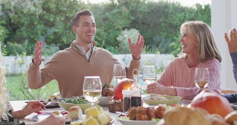 Joyful Family Gathering at Outdoor Dinner Table - Download Free Stock Images Pikwizard.com