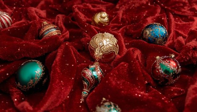 Luxurious christmas baubles on velvet with glittering accents