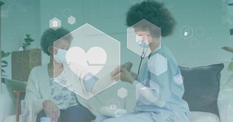 Home nurse measuring blood pressure for senior during masked telehealth care visit on couch