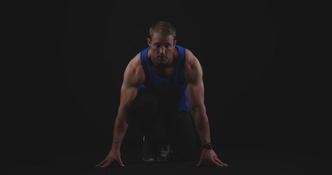 Determined Muscular Male Runner Ready at Starting Line on Black Background - Download Free Stock Images Pikwizard.com
