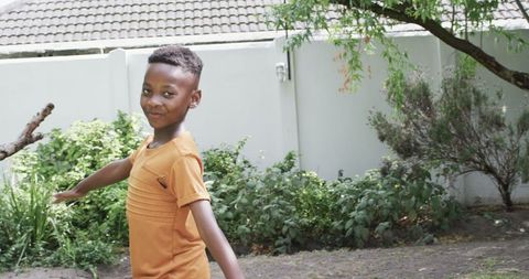 Joyful African American Boy Exploring Garden Outdoors