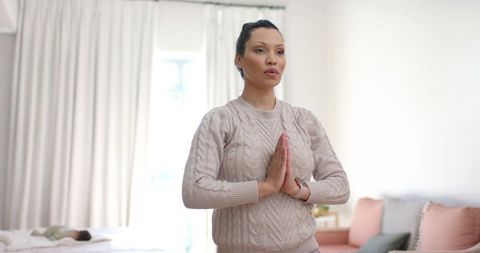 Mother Practicing Yoga in Bedroom with Sleeping Infant Nearby