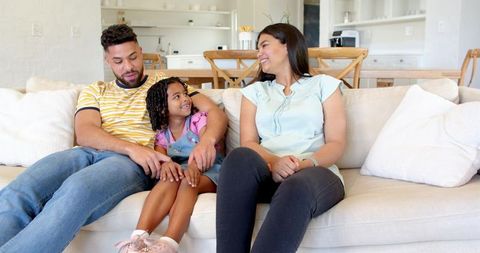 Diverse Family Enjoying Quality Time on Sofa in Bright Living Room