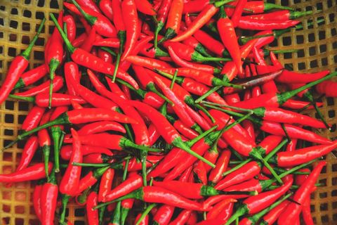 Vibrant Red Chili Peppers in Basket Display
