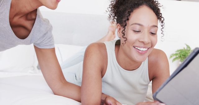 Young Women Using Tablet Device While Relaxing at Home - Download Free Stock Images Pikwizard.com