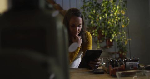 Focused businesswoman using tablet in office workplace