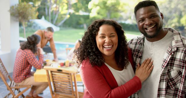 Happy Diverse Couple Smiling at Outdoor Family Gathering - Download Free Stock Images Pikwizard.com