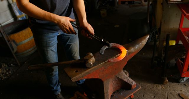 Blacksmith crafting heated iron horseshoe on anvil with hammer - Download Free Stock Images Pikwizard.com