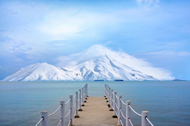 Scenic Pier Leading to Snow-Capped Mountain Vista - Download Free Stock Photos Pikwizard.com