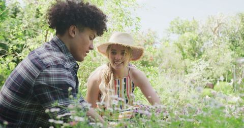 Diverse Couple Enjoying Gardening in Sunny Backyard