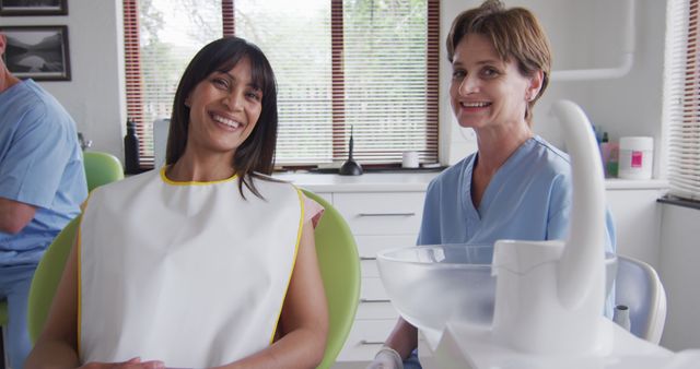 Female Dentist with Patient Wearing Dental Bib in Modern Clinic - Download Free Stock Images Pikwizard.com