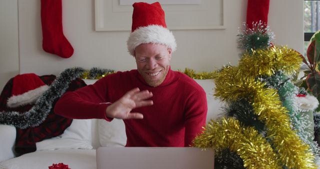 Man in Christmas Hat Video Calling Family on Laptop - Download Free Stock Images Pikwizard.com