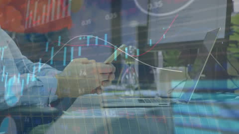 Businessman Analyzing Financial Data on Smartphone and Laptop