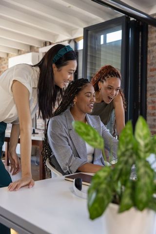 Diverse Businesswomen Collaborating at Office Desk