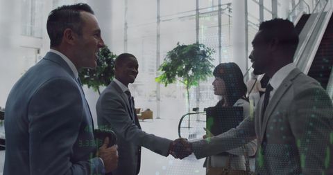 Diverse Professionals Greeting in Modern Office Environment