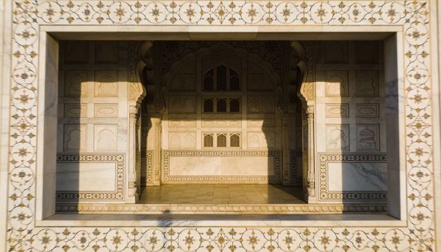 Sunlit marble alcove with intricate pietra dura inlay, jaali lattice and arched niches
