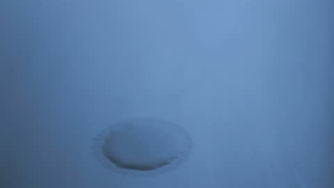 Water Drop Landing in Slow Motion with Calm Blue Hue