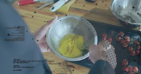 Stirring eggs with whisk on wooden counter, cherry tomatoes and halftone overlay