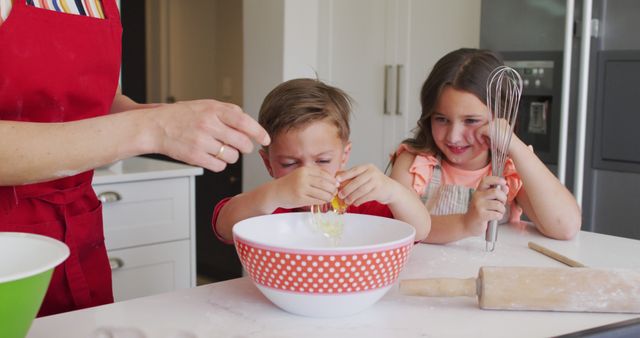 Children baking in kitchen with assistance, cracking eggs into mixing bowl. Suitable for ads or blogs on family activities, cooking classes, homemade recipes, and bonding time. Highlights teamwork, learning, and fun during baking.