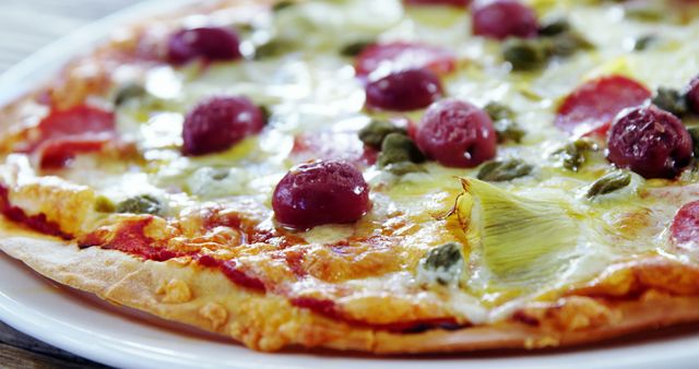 Close-up view of a freshly baked pepperoni pizza featuring rich and melted cheese, vibrant red olives, and green capers. Ideal for use in food blogs, restaurant advertising, or culinary websites to signify gourmet and traditional Italian cuisine.