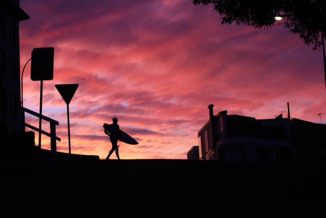 Person's Walking Holding Surf Board during Sunset - Download Free Stock Photos Pikwizard.com