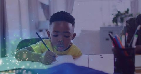 Focused Boy Doing Homework with Magical Lighting Effect