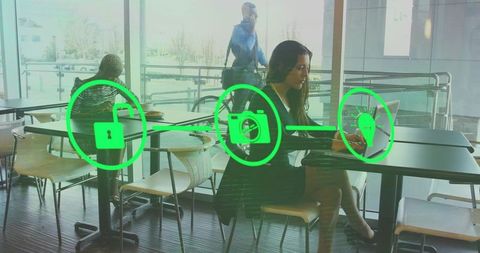 Woman in café typing on laptop surrounded by technological icons