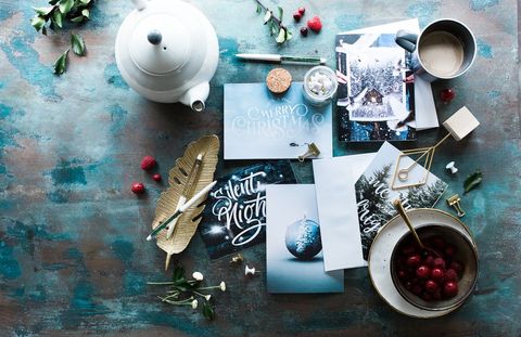 Festive greeting cards with seasonal decor on rustic table
