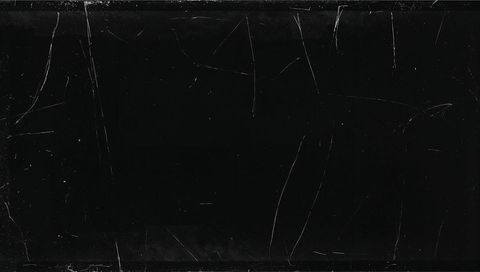 Minimalist worn black panel texture with fine scratches, dust specks and subtle streaks