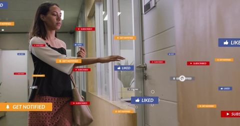 Businesswoman interacting with augmented notifications while entering office corridor