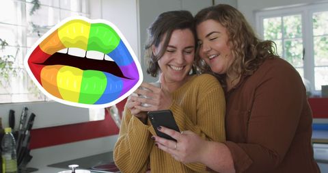Loving Lesbian Couple Enjoying Coffee and Smartphone Together