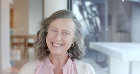 Senior woman relaxing in contemporary minimalist home