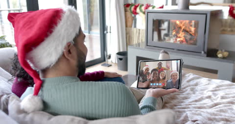 Multicultural Couple Video Calling Friends at Christmas
