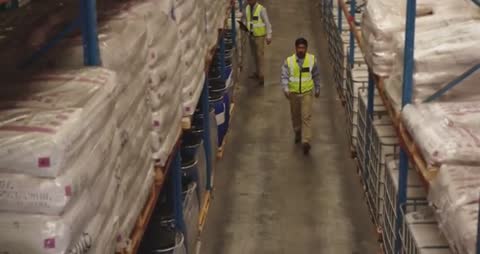 Warehouse Workers Inspecting Inventory in Large Storage Facility