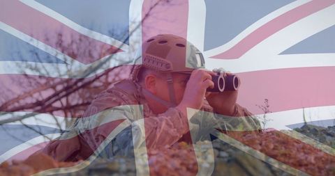 British Soldier Scanning Terrain with Binoculars Under Union Jack Overlay for Security