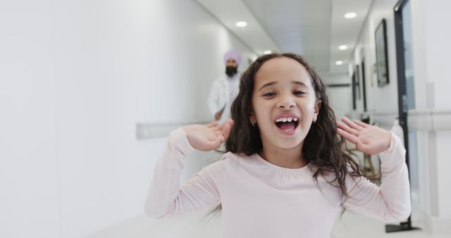 Happy Girl Excitedly Walking in Hospital Hallway - Download Free Stock Images Pikwizard.com