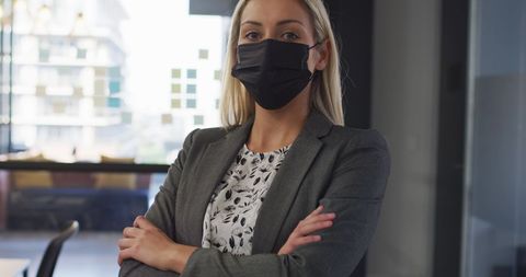 Confident Businesswoman Wearing Face Mask in Modern Office - Download Free Stock Images Pikwizard.com