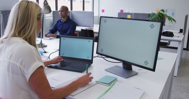 Employees Working at Modern Office Desk With Empty Display Screens - Download Free Stock Images Pikwizard.com