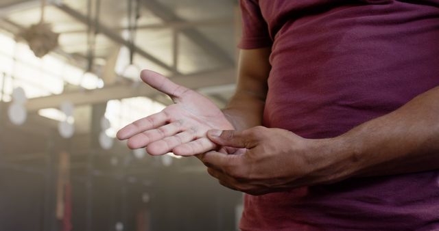 Close-Up of Man Checking Hand Injury in Gym - Download Free Stock Images Pikwizard.com