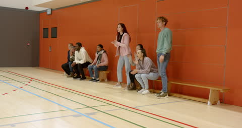 Enthusiastic Group Cheering in School Gymnasium